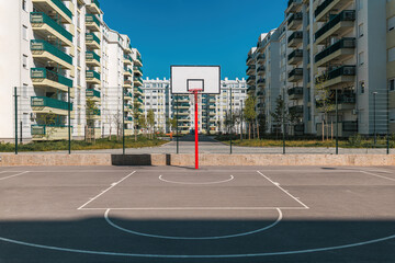 Fototapeta Outdoor basketball court with asphalt surface in residential district obraz