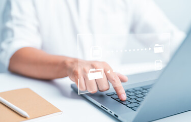 Businessman use laptop computer to transfer data or document on internet network. Data file sent or...