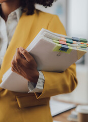 Businessman working in financial accounting with piles of documents on the desk at home work from...