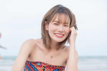 young slim beautiful woman on sunset beach, playful, summer vacation, sunny, having fun, positive mood, romantic, traveller, happy, Happy mixed race girl in casual outfit with wind in her hair.