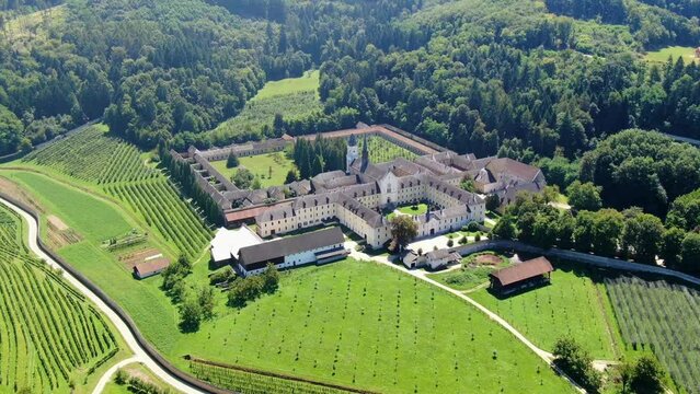 Carthusian monastery in Slovenia in a green valley surrounded by vineyards, orchards and forests