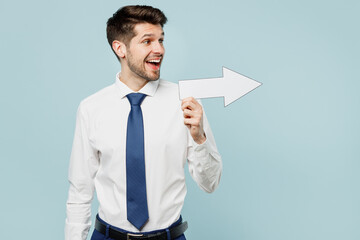 Young surprised happy employee IT business man corporate lawyer wear classic formal shirt tie work in office showing aside with arrow isolated on plain pastel light blue background studio portrait.