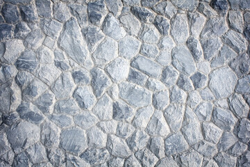 Gray pattern uneven decoration stone wall texture with cement for background.