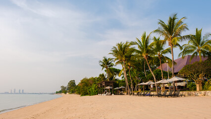 Fototapeta na wymiar Beach of Bangsaray Pattaya Thailand at sunset with beach chairs and sunbeds