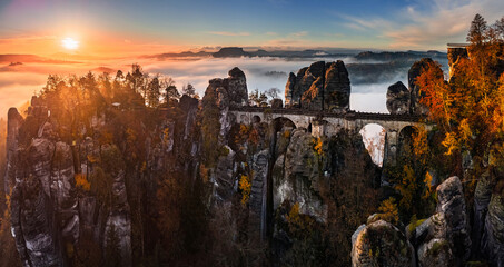 Saxon, Germany - Aerial panoramic view of the Bastei bridge on a foggy autumn morning. Bastei is famous for the beautiful rock formation in Saxon Switzerland National Park near Dresden