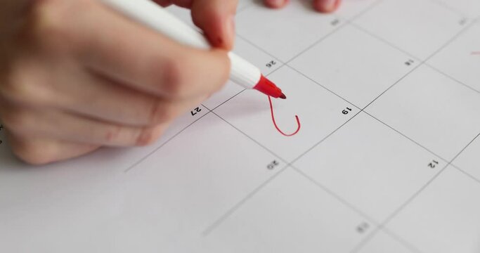 Red heart shape for date 19 day in calendar. Woman marks an important calendar date