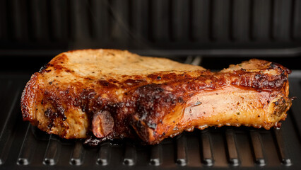 Frying pieces of juicy pork meat on grill