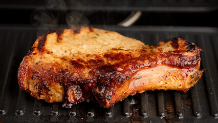 Frying pieces of juicy pork meat on grill