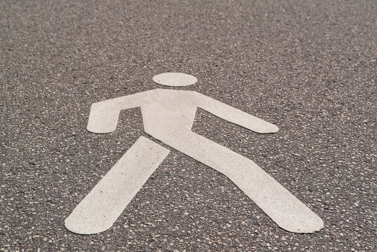 a sign indicating a footpath painted on the sidewalk close-up