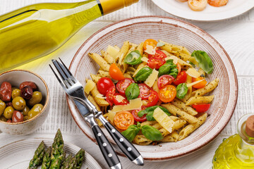 Italian pasta adorned with fresh tomatoes and aromatic basil