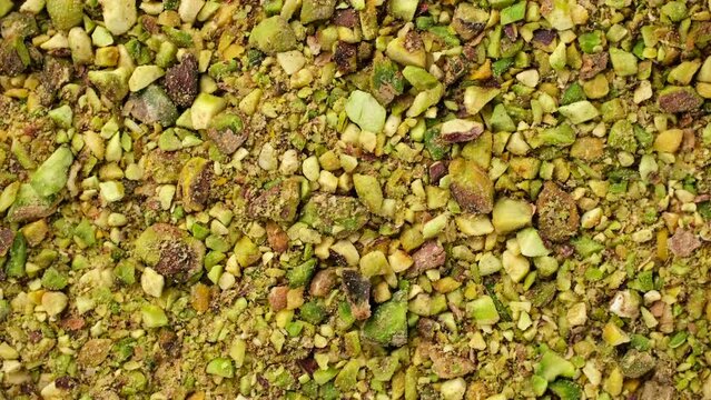 Ground pistachios close up, rotate.  Ingredients for bakery and dessert