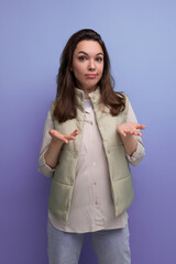 young brunette woman upset and in doubt over isolated background