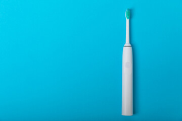 Sonic electric toothbrush on a blue background. Oral hygiene. Dental care. Dentistry concept. Place for text. Place to copy.