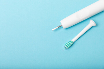 Sonic electric toothbrush on a blue background. Oral hygiene. Dental care. Dentistry concept. Place for text. Place to copy.