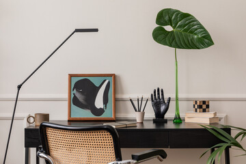 Elegant composition of living room interior with mock up poster frame, black desk, rattan armchair,...