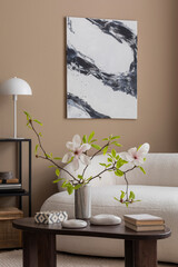 Cozy composition of spring living room interior with mock up poster frame, boucle sofa, vase with magnolia, wooden coffee table, books, white lamp and personal accessories. Home decor. Template.