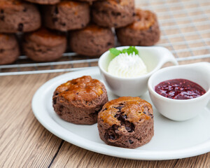 Chocolate scone with clotted cream and homemade raspberry jam