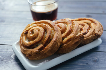 Buns on a wooden background. Break during the day to chat with friends and family over coffee and cake.