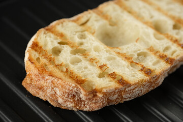 Fresh ciabatta bread on grill. 
Ciabatta bread holes