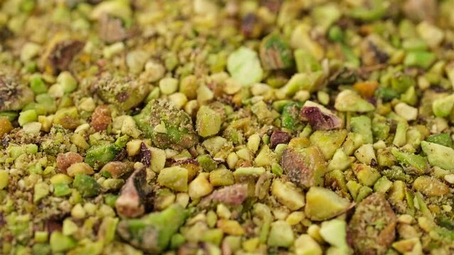 Ground pistachios close up, rotate.  Ingredients for bakery and dessert