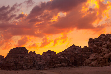 Sunset colorful orange sky landscape with sandstone rocks in Little Petra archaeological site,...
