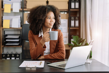 Businesswoman taking break while working from home.and enjoys a coffee.