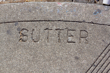 sutter street is market at the concrete of the sidewalk in San Francisco