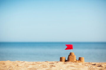 sand castle on sandy seashore in summer. family vacation by beach of sea.