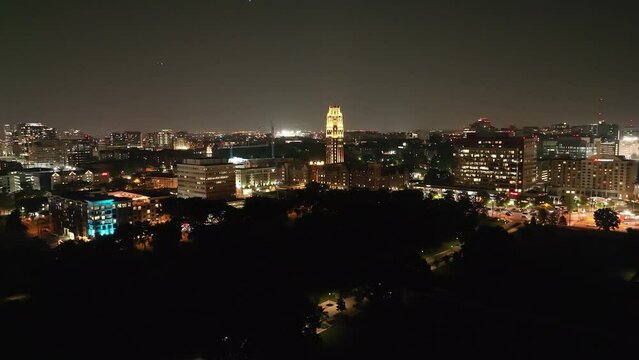 Vanderbilt University West End Tower at night with drone video moving in wide shot.