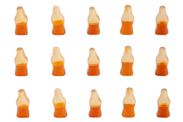 Cola flavored gummy jellies in the shape of cola bottles,isolated over transparent background.