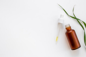 Bottle with dropper lid and herbs - cosmetic serum essential oil