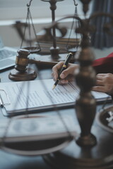 Justice and law concept.Male judge in a courtroom with the gavel, working with, computer and...