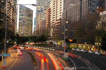 George st Sydney city at dusk with lights in buildings, street lights and car lights