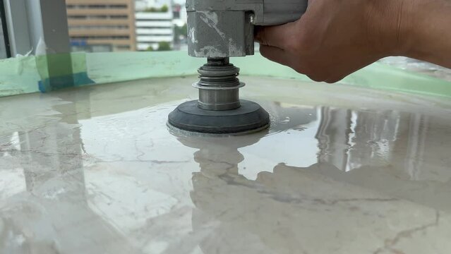 Professional polishing of a marble top using an angle grinder
