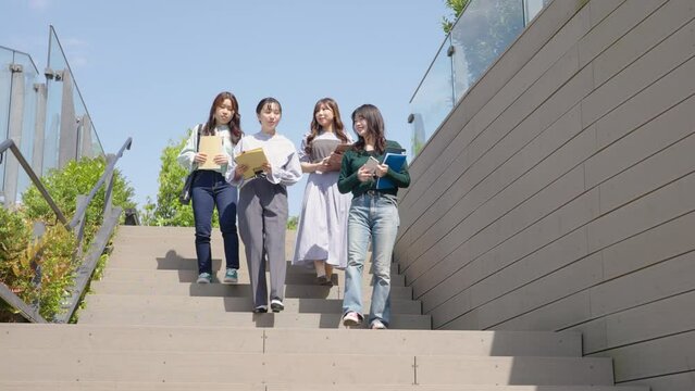 仲良く歩く若い女性4人
