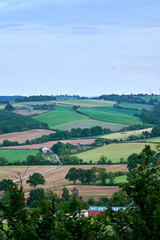 Fototapeta na wymiar Portrait view over english rolling hills and farm fields in countryside