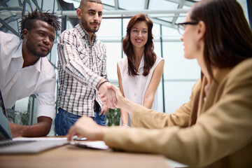 Manager shaking the hand of a female applicant