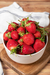 Strawberry in bowl. Organic farm products. Fresh strawberries on wooden background. Close up