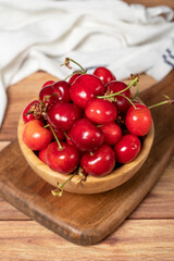 Fototapeta na wymiar Cherry in bowl. Organic farm products. Fresh cherry on wooden background. Close up