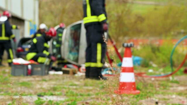 Firefighters during a rescue operation training. Rescuers unlock the passenger in car after accident. High quality 4k footage