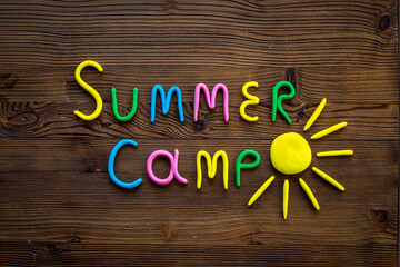 Summer Camp made of color clay with sun. Camping background
