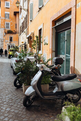 Italian scooter parking at old building in rome, traveling background. Typical street in Rome, Italy.