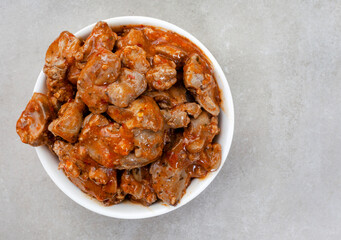 Traditional South African Per Peri chicken livers on mottled grey surface