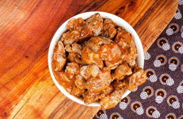 Traditional South African Per Peri chicken livers on wood with traditional South African printed fabric