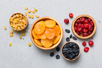 Bowl with different dried fruits on table background, top view. Healthy lifestyle with copy space
