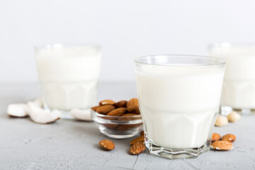 Set or collection of various vegan milk almond, coconut, cashew, on table background. Vegan plant based milk and ingredients, top view