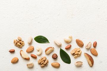 Fototapeta na wymiar Composition of nuts , flat lay - mix hazelnuts, cashews, almonds on table background. healthy eating concepts and food background