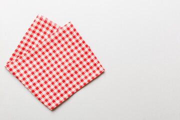 Fototapeta na wymiar top view with red empty kitchen napkin isolated on table background. Folded cloth for mockup with copy space, Flat lay. Minimal style