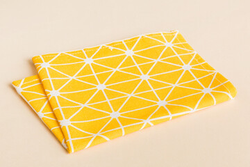 top view with yellow empty kitchen napkin isolated on table background. Folded cloth for mockup with copy space, Flat lay. Minimal style