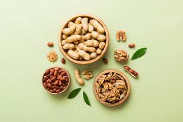 Walnut kernel halves, in a wooden bowl. Close-up, from above on colored background. Healthy eating Walnut concept. Super foods with copy space